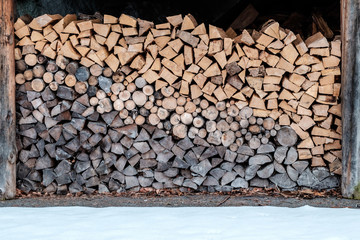 A woodpile, with lots of wood stored for the winter