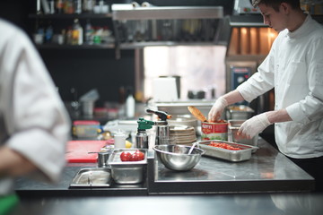 Restaurant Chef cook preparing sea food in open kitchen at restaurant.