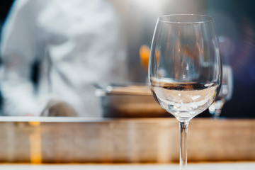 Close up of glass with sparkling champagne with bubbles in the restaurant.