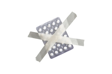 antidepressant pills are taped on a white background