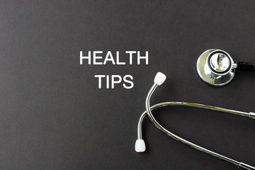 Health Tips text with stethoscope , health and medical concept.