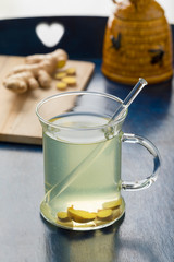 Glass cup with ginger tea and honey