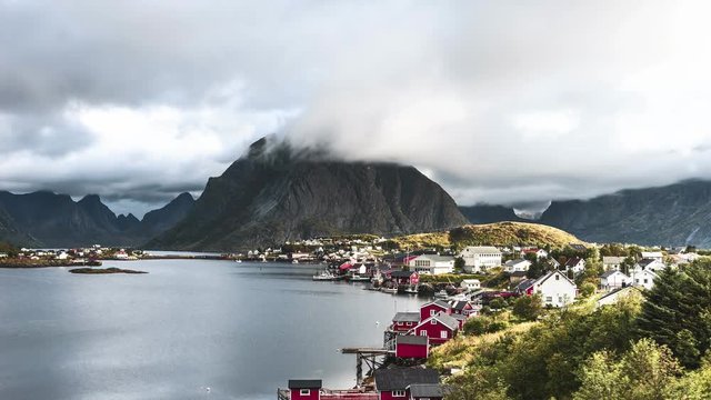 4k Timelapse movie film clip of Moving clouds over traditional Norwegian fisherman's cabins, rorbuer, on the island of Hamnoy, Reine, Lofoten islands, Norway 4K.