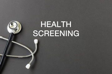 Health screening text with stethoscope , health and medical concept.