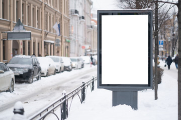 Vertical mock-up of city poster winter city with thick edges, blank white billboard in urban settings, empty street information placeholder on sidewalk with copy space for logo