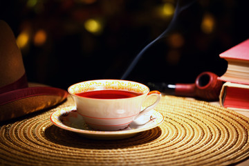 hot tea cup gold bokeh hat smoking pipe 