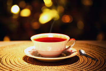 hot tea cup gold bokeh 