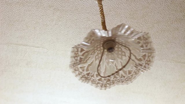 Noisy neighbors. Chandelier swinging on the ceiling