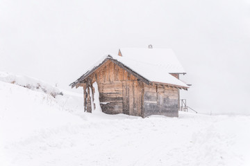 rural log cabin on snowy mountain.