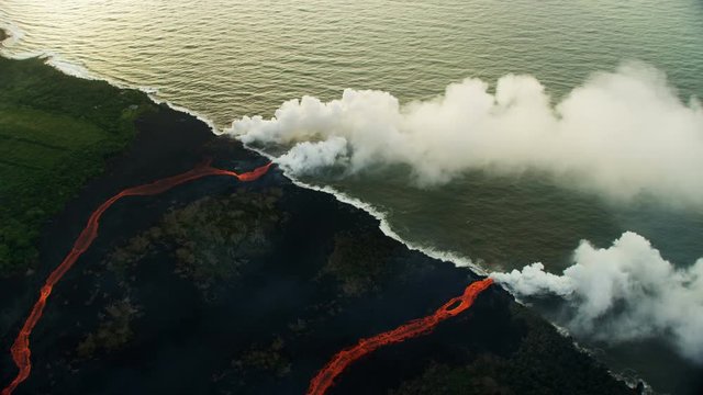 Aerial view red hot lava pouring into Pacific
