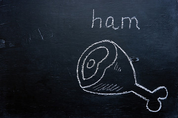Ham drawing with chalk on black board, copy space