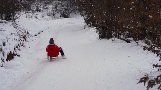 Children sledging on snow - (4K)