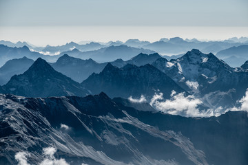 Fototapeta na wymiar Alpine mountain range fog layers, Tauern, Grossglockner, Austria