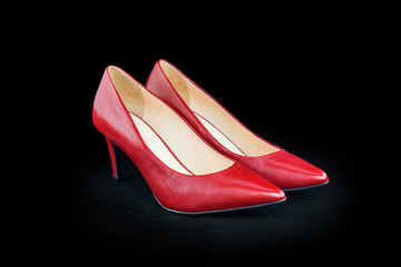 Women's shoes made of red leather on a black background