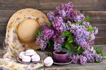 Composition with lilac, tea cup and zephyr cookies