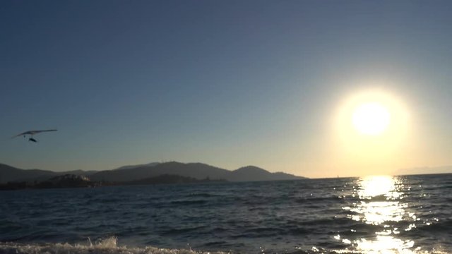 Fethiye, Turkey - 19th of October 2017: International Air Games on the Calis beach - 4K Ultralight Birdman fly above the sea