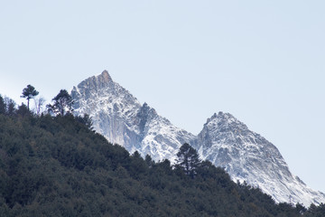 Mountain tops behind a forest from an early morning on the Everest base camp trek.