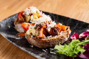 Sandwich with cheese, tomato, and gourmet sauce