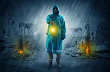Destroyed place after a catastrophe with man in raincoat and lantern concept
