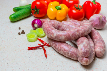 Assorted raw sausage for barbecue with vegetables.
