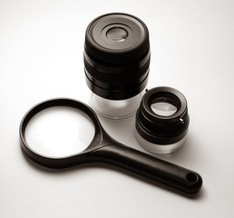 Different types of magnifying glasses: a one simple loupe, one with a doubly-convex lens, one with a constituent of several, and magnifier lens with a zoom effect. Objects isolated on white backround