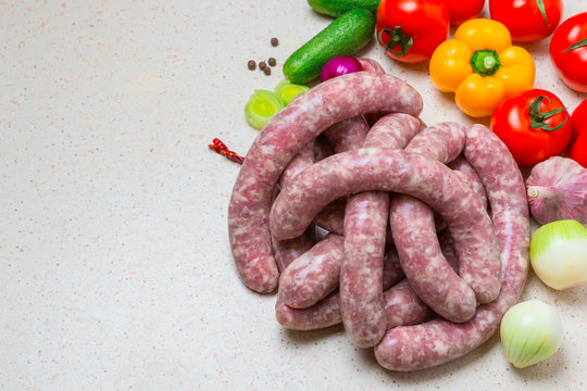 Assorted raw sausage for barbecue with vegetables.