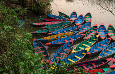 Boats in fewa lake in Pokhara, Nepal at sunrise before they go away for the day. 