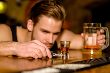 Do not drive drunk. Man drinker with car keys in pub. Handsome man drink beer at bar counter. Alcohol addict with beer mug. Alcohol addiction and bad habit. Addicting to alcoholic drink