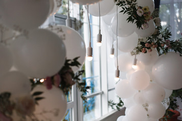 an arch of white balloons .
festive decor for the wedding.
decor of balloons and lights.
wedding...