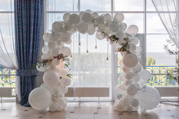 an arch of white balloons .
festive decor for the wedding.
decor of balloons and lights.
wedding...