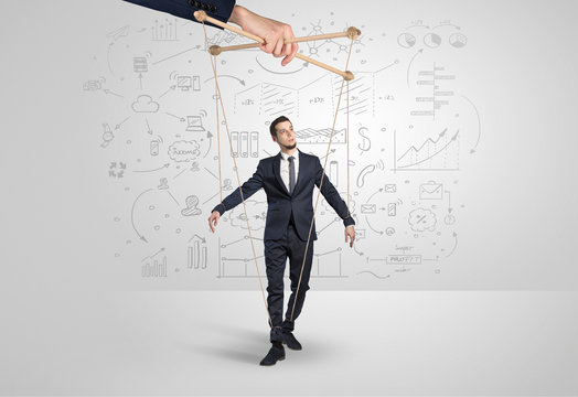 Little businessman controlled from above like a puppet concept

