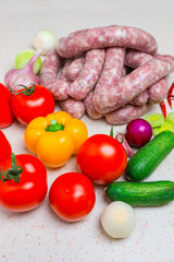 Assorted raw sausage for barbecue with vegetables.