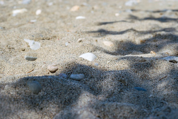 Fototapeta na wymiar Beach sand stone shadow