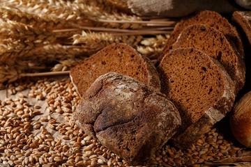 Assortment of baked bread on wooden table background