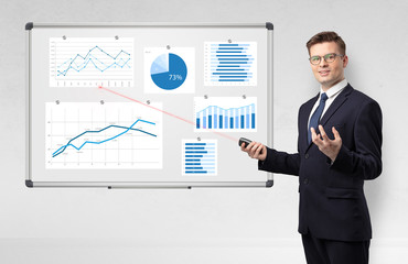 Handsome businessman presenting report on white board with laser pointer 
