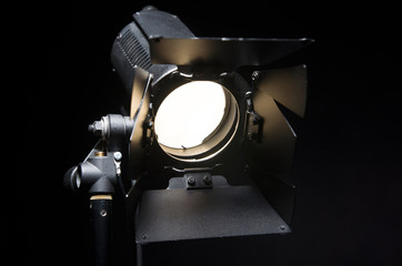 Floodlight with halogen lamp and Fresnel lens. Lighting equipment for shooting. Filming and...