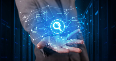 Man holding hologram projection displaying cloud technology symbols
