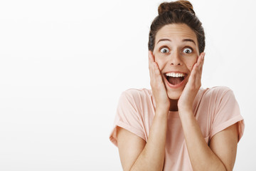 Portrait of surprised enthusiastic girl reacting to awesome unexpected surprise winning trip around...