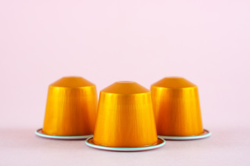 Orange collection of espresso coffee machine capsules  on pink background.