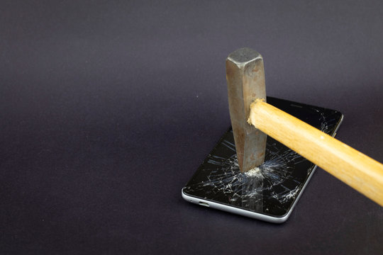 Phone screen crash or durability, endurance test concept on the black background. It could be used in technological area, news, etc.