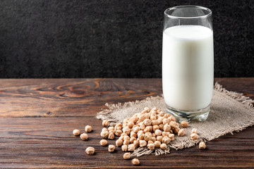 Chickpeas milk on dark wooden background.
