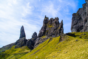 Travel Europe, Scotland, Highlands, Isle of Skye (Tourist popular destination). Scenic mountain landscape view of The Old Man Of Storr attraction, sharp rocks and lakes on background in summer time.