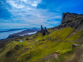 Fototapeta na wymiar Travel Europe, Scotland, Highlands, Isle of Skye (Tourist popular destination). Scenic mountain landscape view of The Old Man Of Storr attraction, sharp rocks and lakes on background in summer time.