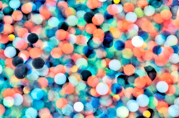 Fototapeta na wymiar polymer water beads diffused in water