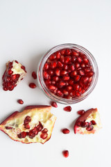 Fresh pomegranate on white background. Top view with copy space.