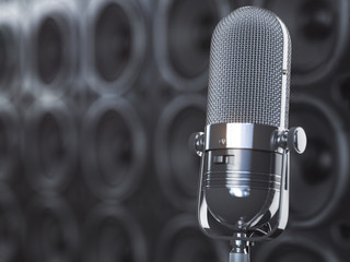 Microphone on black background from  professional loudspeakers and subwoofers. Audio and music concept.
