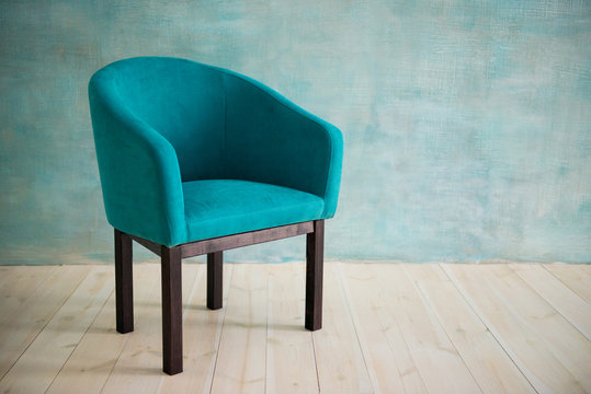 Blue chair against the blue wall. Interior