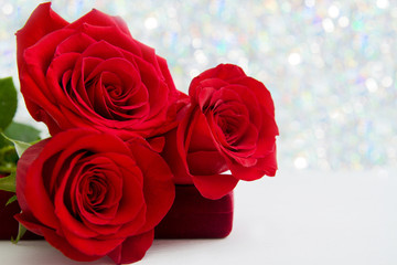 Three Red Roses and jewelery present box with boke Background. copy space - Valentines and 8 March Mother Women's Day concept.