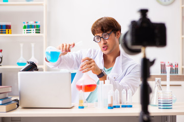 Fototapeta premium Chemist blogger recording video for his blog