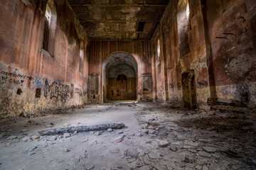 Abandoned interior of a church standing in the middle of the forest, completely empty.